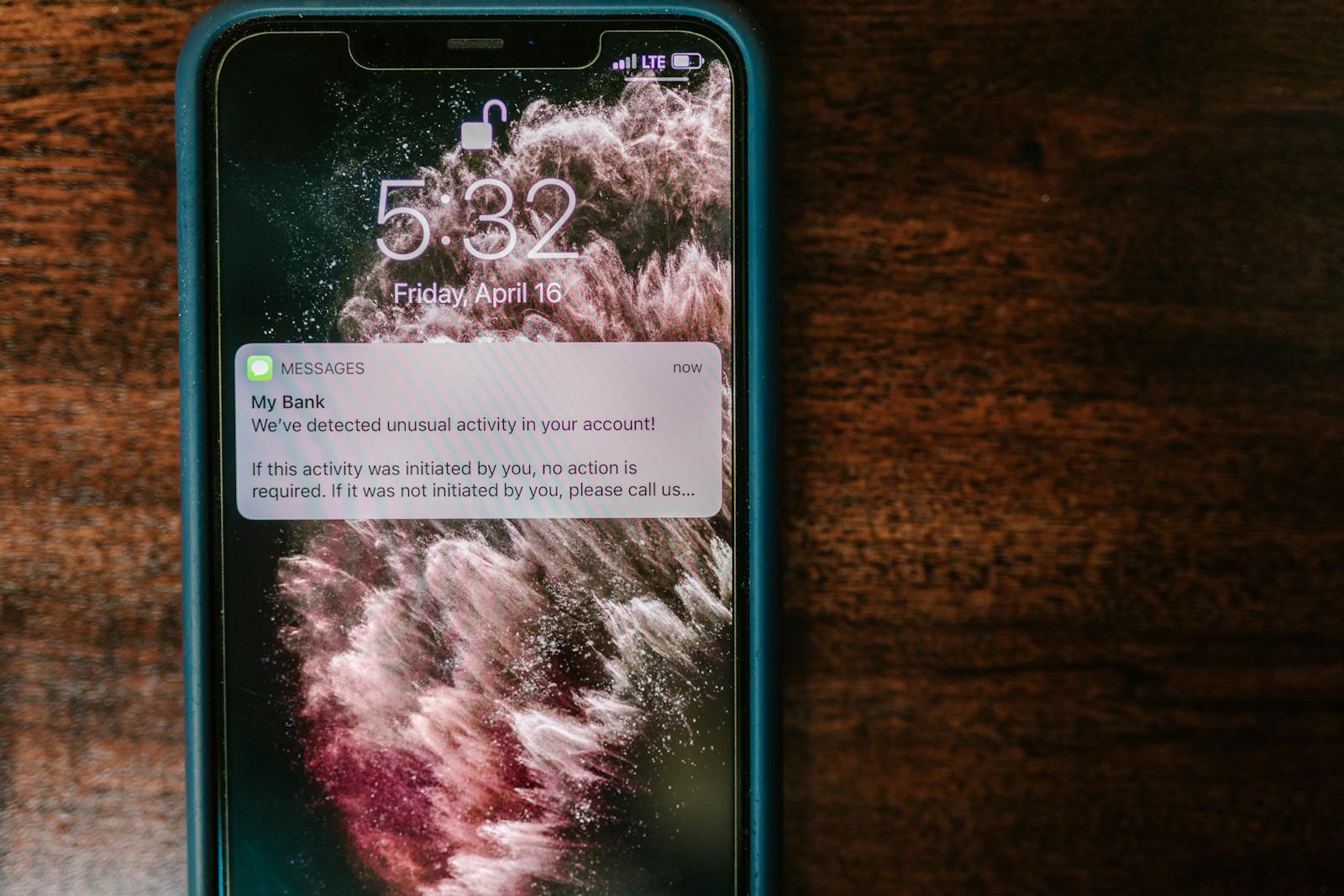 A hand holding a smartphone displaying a text-message verification code — photo by RDNE Stock project on Pexels